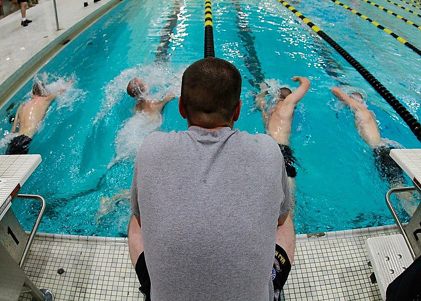 Child swimming along a pool lane