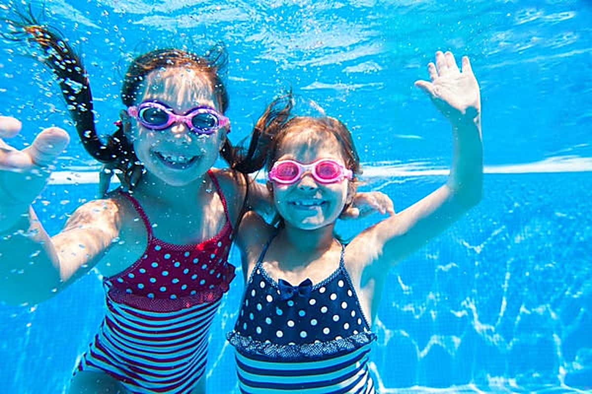 Two girls swimming underwater